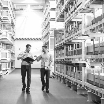Two men working in factory warehouse